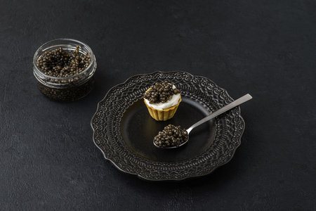 black caviar on a black background. High quality photoの写真素材