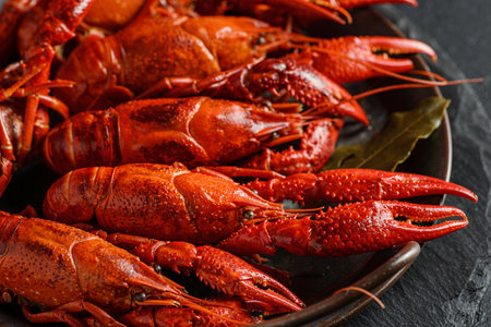 boiled crayfish on a black plateの写真素材