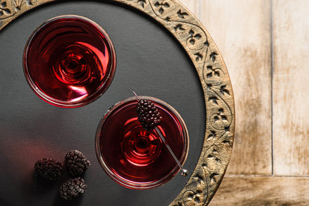 cocktail with juice decorated with blackberriesの写真素材