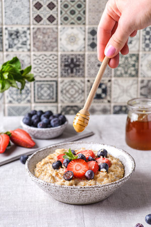 oatmeal porridge with berries and honeyの写真素材