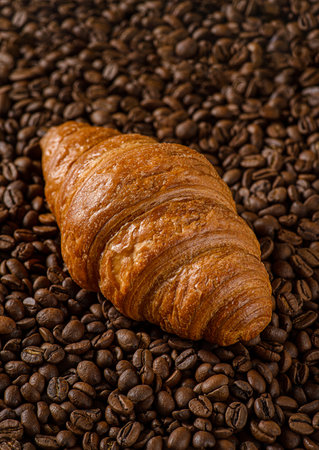 croissant on a dark background with coffee beans. High quality photoの写真素材