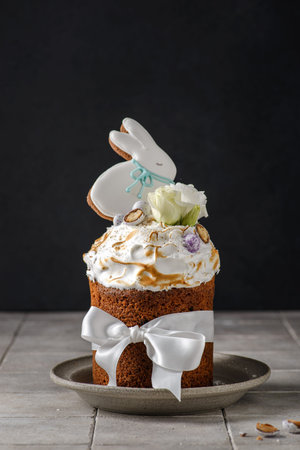 Easter cake on a dark background decorated with Easter chocolate eggs and Easter gingerbread rabbit