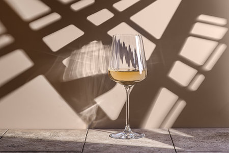 wine in a glass on a beige backgroundの写真素材