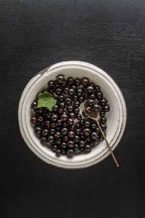 black currant on a light plate. High quality photo