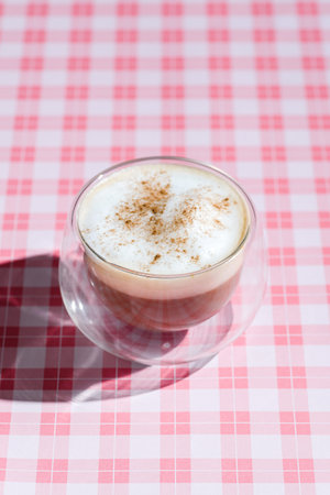 cappuccino with cinnamon on a pink background. High quality photo