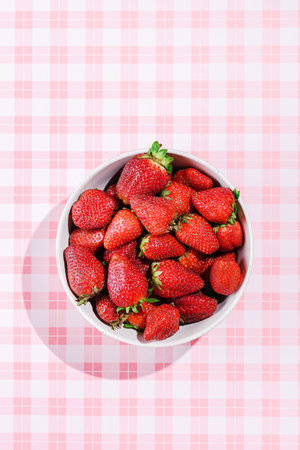 strawberries in a bowl on a pink background. High quality photoの写真素材