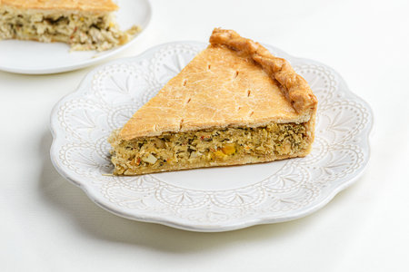 Chicken and egg pie on a light plate.の写真素材