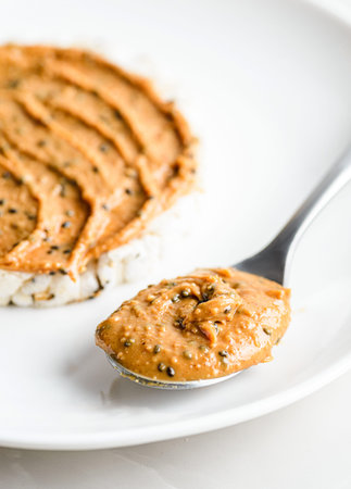 peanut paste with chia on rice bread on a light background. High quality photo