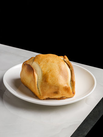 empanadas on a plate on a table in a restaurantの写真素材