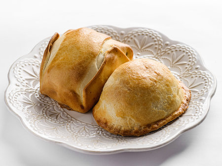 traditional Latin American empanadas on a white plate. High quality photo