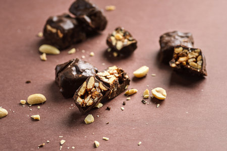 chocolate candy bars bonbon with nuts on a brown background, horizontalの写真素材