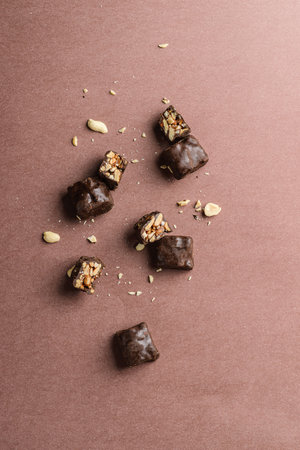 chocolate candy bars bonbon with nuts on a brown background.の写真素材