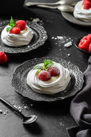 Pavlova meringue dessert with raspberries and cream. The dessert is made from egg whites and powdered sugar, as well as whipped cream and cottage cheese.の写真素材