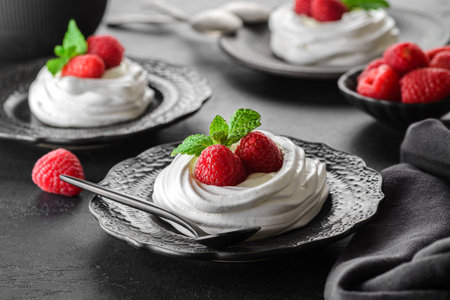 Pavlova meringue dessert with raspberries and cream. The dessert is made from egg whites and powdered sugar, as well as whipped cream.の写真素材