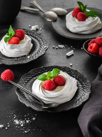 Pavlova meringue dessert with raspberries and cream. The dessert is made from egg whites and powdered sugar, as well as whipped cream.の写真素材