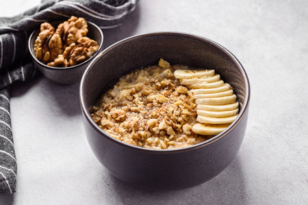 oatmeal porridge with banana, honey and walnuts. High quality photoの写真素材
