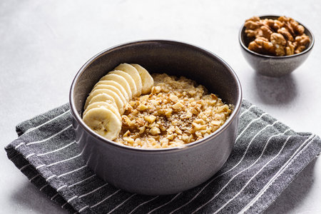 oatmeal porridge with banana, honey and walnuts. High quality photoの写真素材