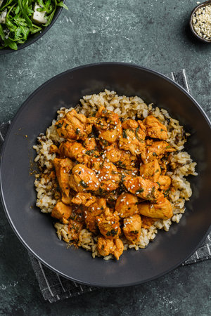 chicken in curry sauce with rice and sesame seeds.の写真素材