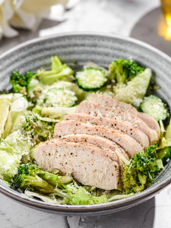 green salad with chicken, cucumber and broccoli. seasoned with olive oil and lemon juiceの写真素材