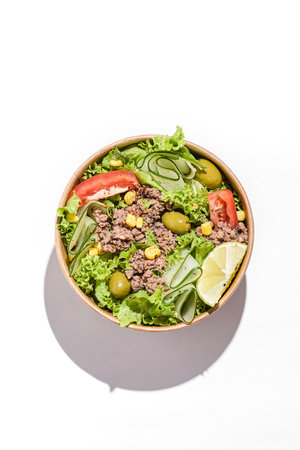 salad with tomatoes, cucumber and olives in a cardboard container. High quality photoの写真素材