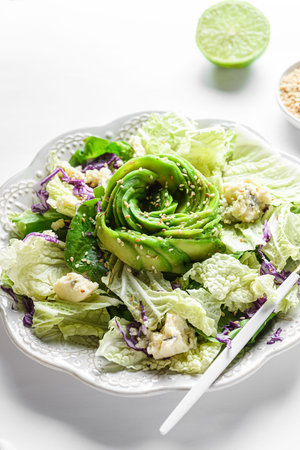 vegetarian salad with cabbage, cheese with mold and avocado food styling in the form of a rose. The...