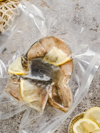 mackerel with lemon in a package on a gray background. High quality photoの写真素材