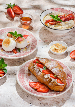 croissant with strawberries and mascarpone and cheesecakes with strawberriesの写真素材