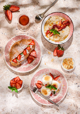 cottage cheese cheesecakes with strawberries, croissant and porridge with strawberries. breakfast in the restaurantの写真素材