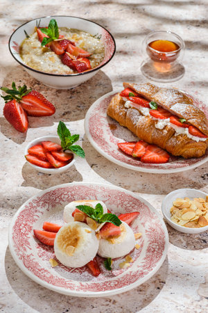 cottage cheese cheesecakes with strawberries, croissant and porridge with strawberries. breakfast in the restaurantの写真素材