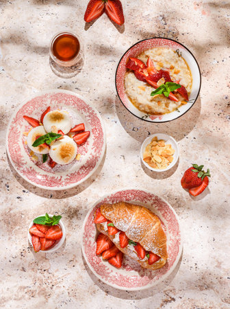 cottage cheese cheesecakes with strawberries, croissant and porridge with strawberries. breakfast in the restaurantの写真素材