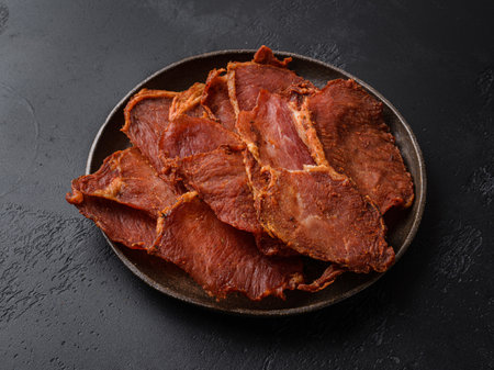 pork dried chips on a black backgroundの写真素材