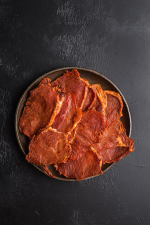 pork dried chips on a black backgroundの写真素材