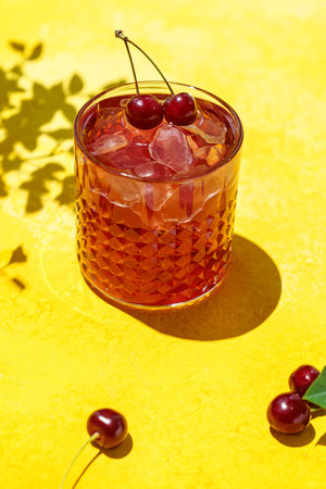 cherry juice on a yellow background. High quality photoの写真素材