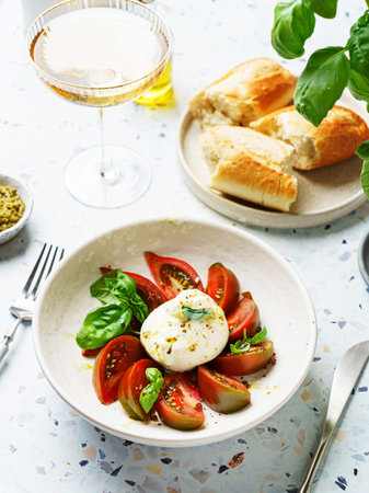 burrata with tomatoes, basil and pesto. High quality photo