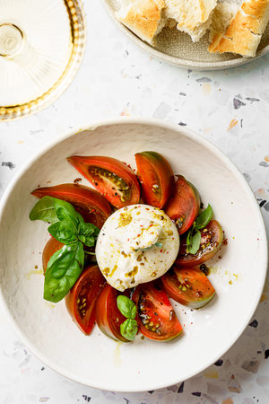 burrata with tomatoes, basil and pesto. High quality photo