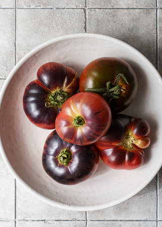 black tomatoes on a dark background. High quality photoの写真素材