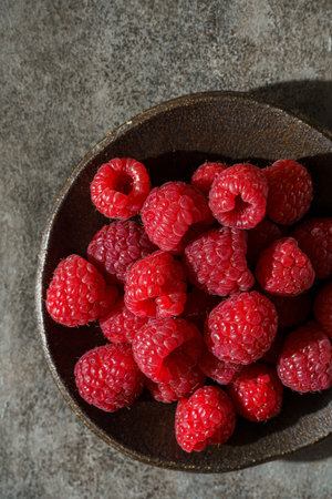raspberries in a black dish. High quality photo