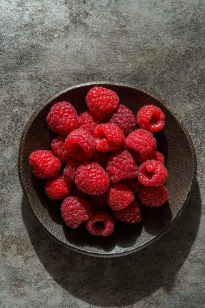 raspberries in a black dish. High quality photo