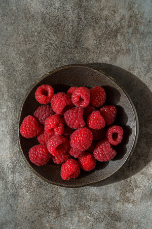 raspberries in a black dish. High quality photo