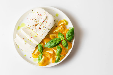 feta cheese with yellow tomatoes and basil. High quality photoの写真素材