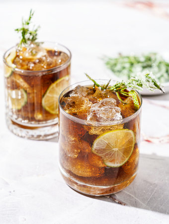 whiskey and coke, garnished with lime and sugar rosemary. High quality photoの写真素材