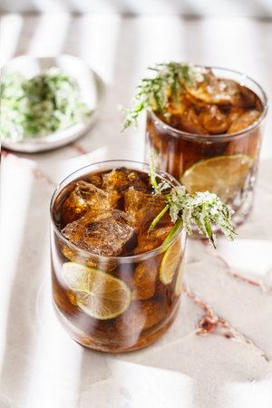 whiskey and coke, garnished with lime and sugar rosemary. High quality photo