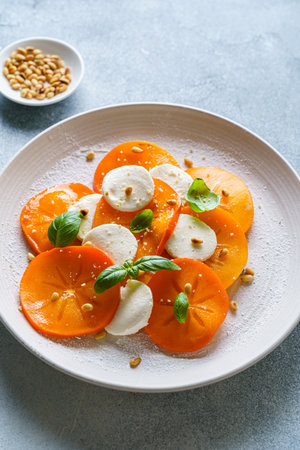 caprese salad with persimmon and mozzarella. High quality photoの写真素材