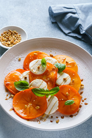 caprese salad with persimmon and mozzarella. High quality photoの写真素材