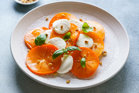 caprese salad with persimmon and mozzarella. High quality photoの写真素材