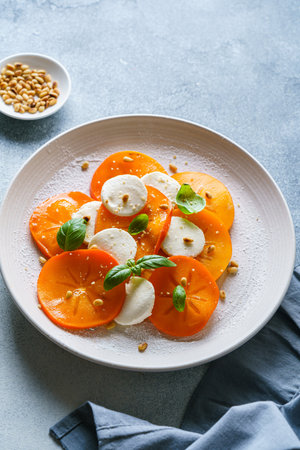 caprese salad with persimmon and mozzarella. High quality photoの写真素材