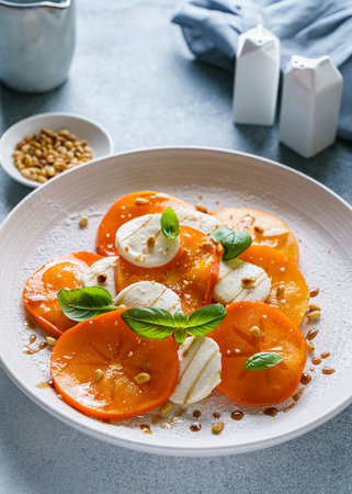 caprese salad with persimmon and mozzarella. High quality photoの写真素材