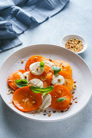 caprese salad with persimmon and mozzarella. High quality photoの写真素材