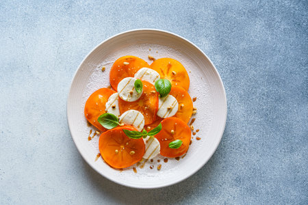 caprese salad with persimmon and mozzarella. High quality photoの写真素材