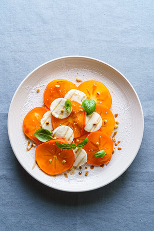caprese salad with persimmon and mozzarella. High quality photoの写真素材